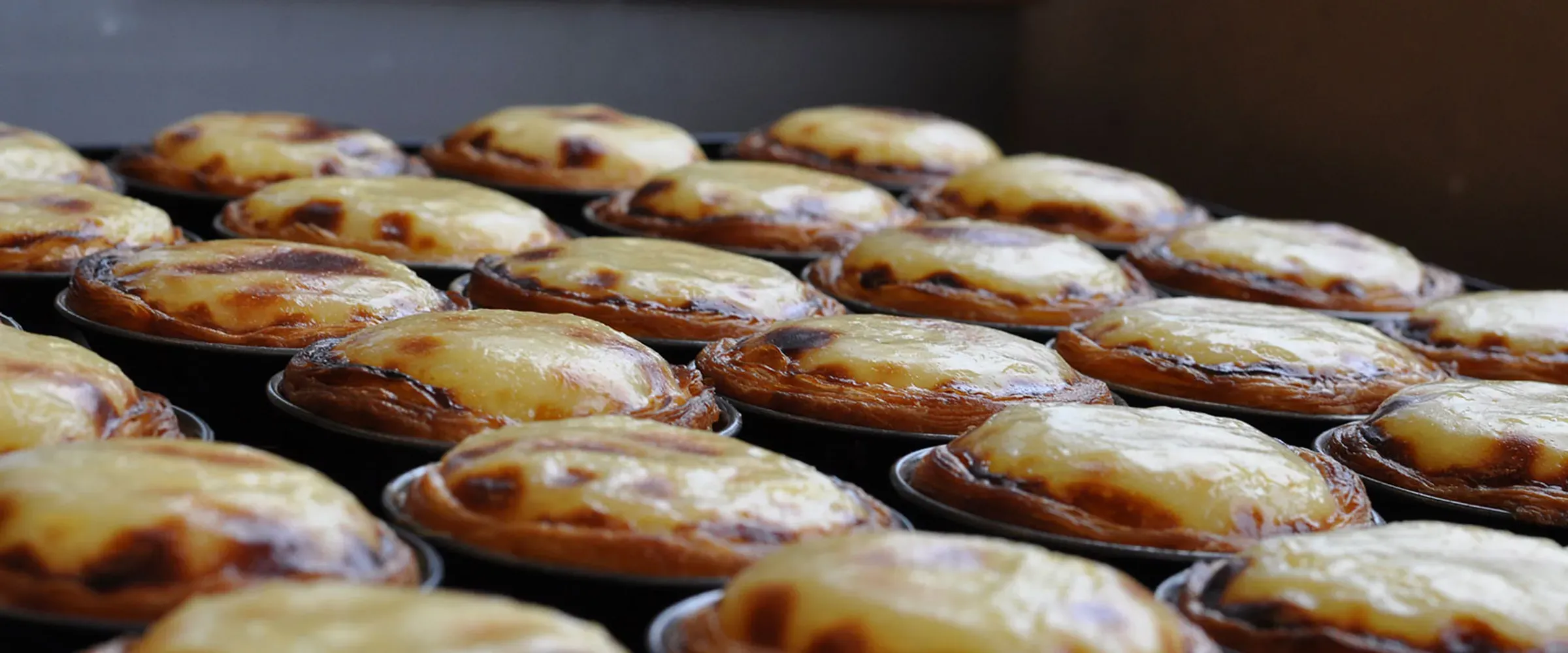 Person carrying Portuguese Tarts